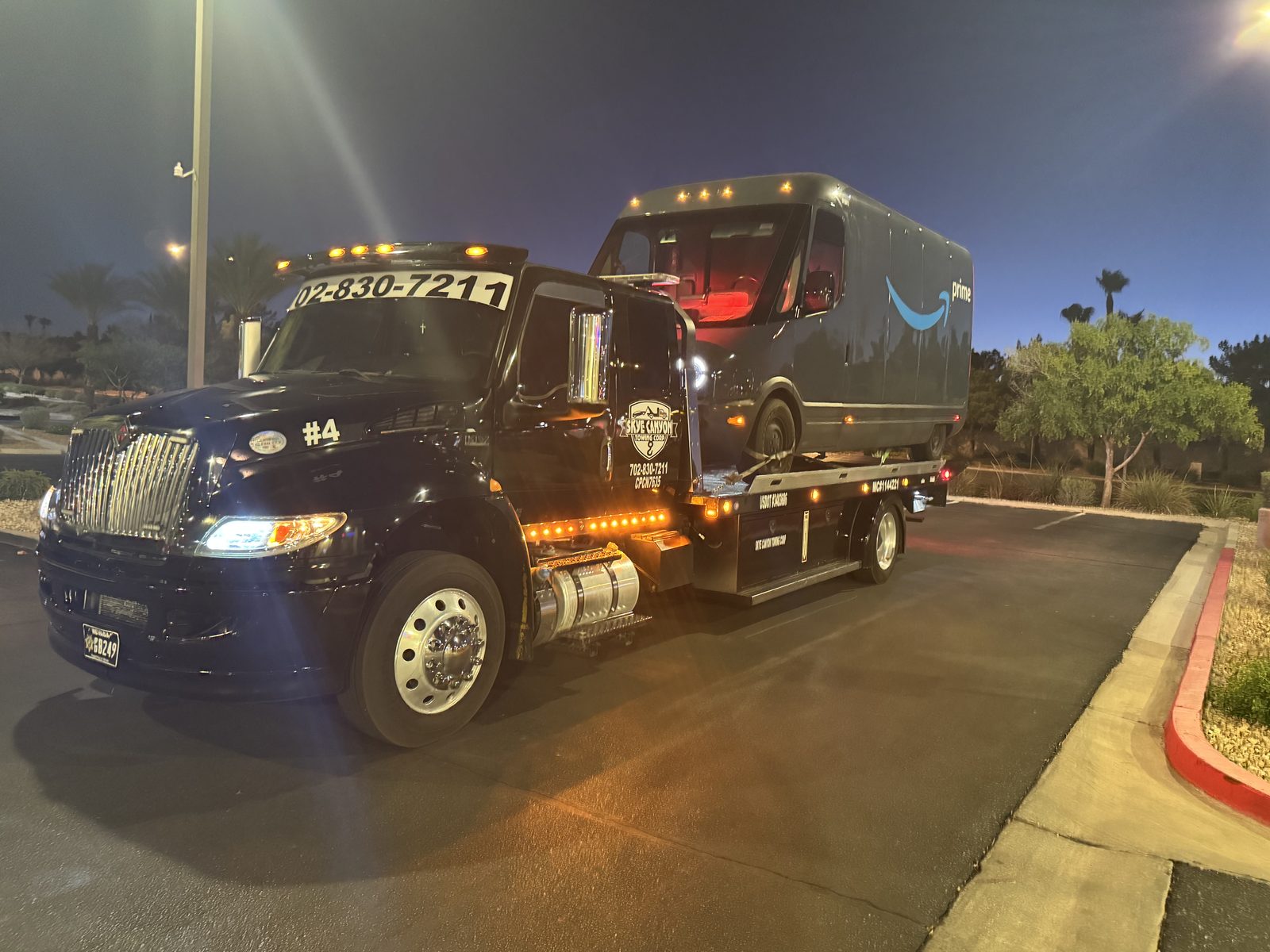 Amazon delivery van on a flatbed during an overnight tow in Las Vegas