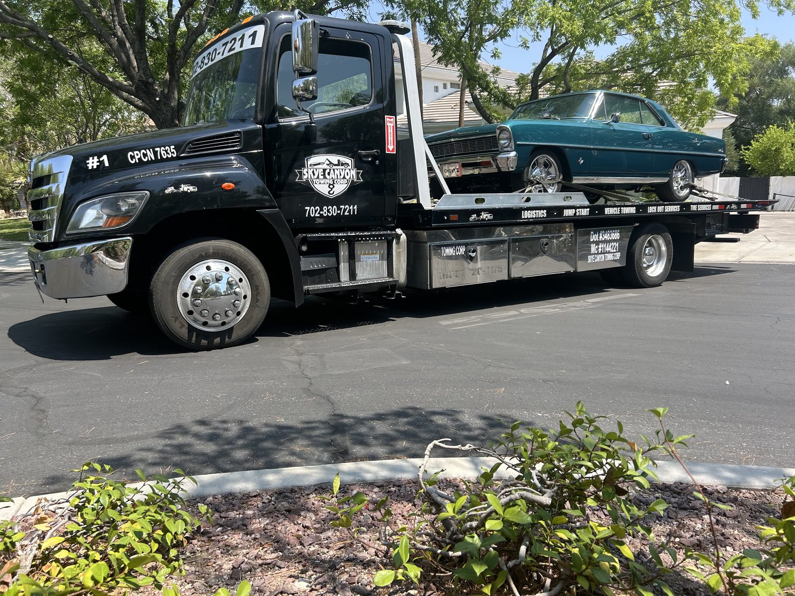 Flatbed tow truck hauling a classic car in Las Vegas
