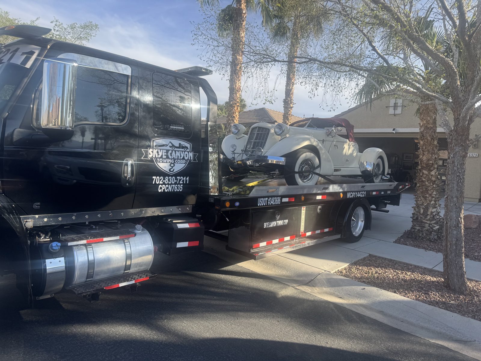 Vintage convertible on a flatbed for a careful classic car tow in Summerlin
