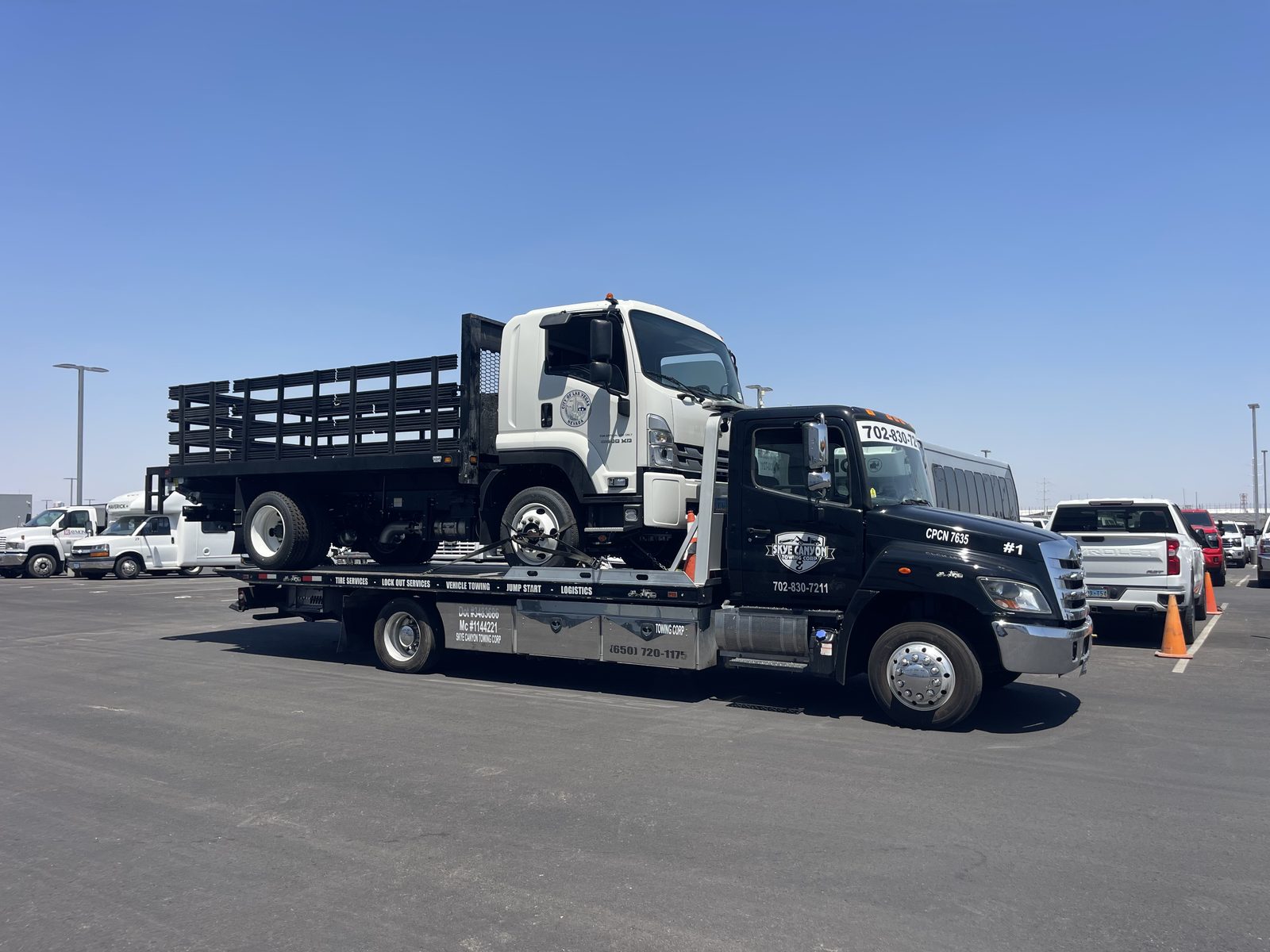 Heavy duty stake truck transport by Skye Canyon Towing