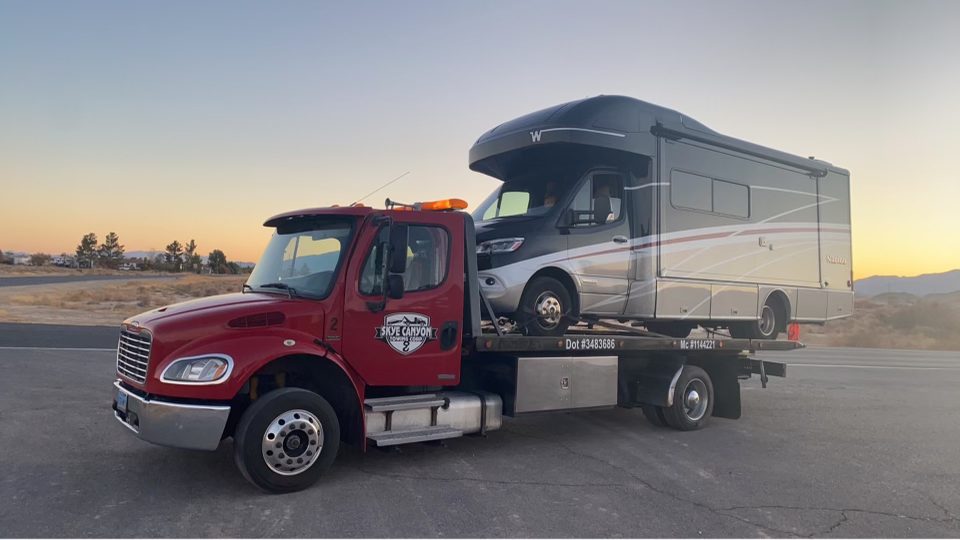 RV motorhome recovery at sunset by Skye Canyon Towing